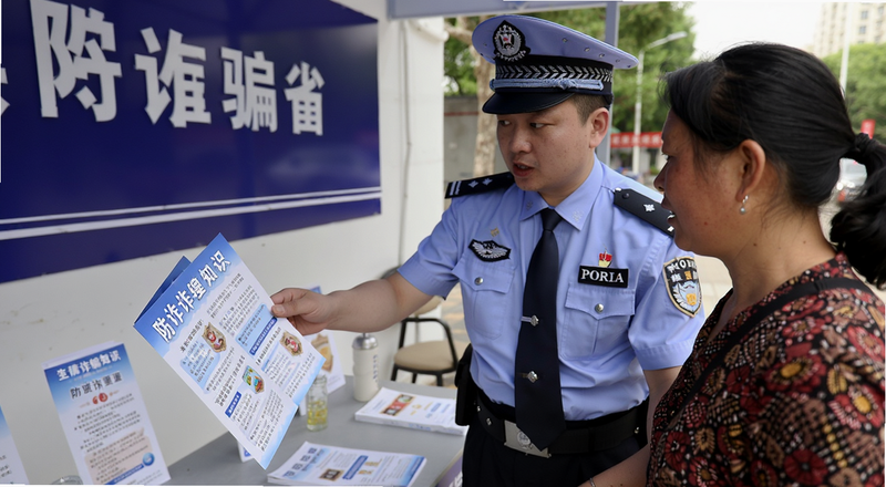 警察向市民讲解防诈骗知识宣传册